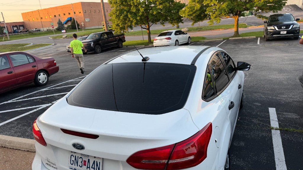 White sedan rear view showing 20% VLT tint on the back windshield