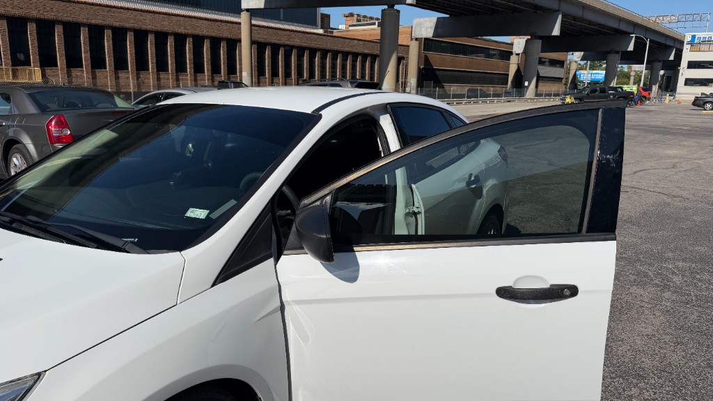 White sedan with front door open showing contrast between 35% front and 5% rear tint