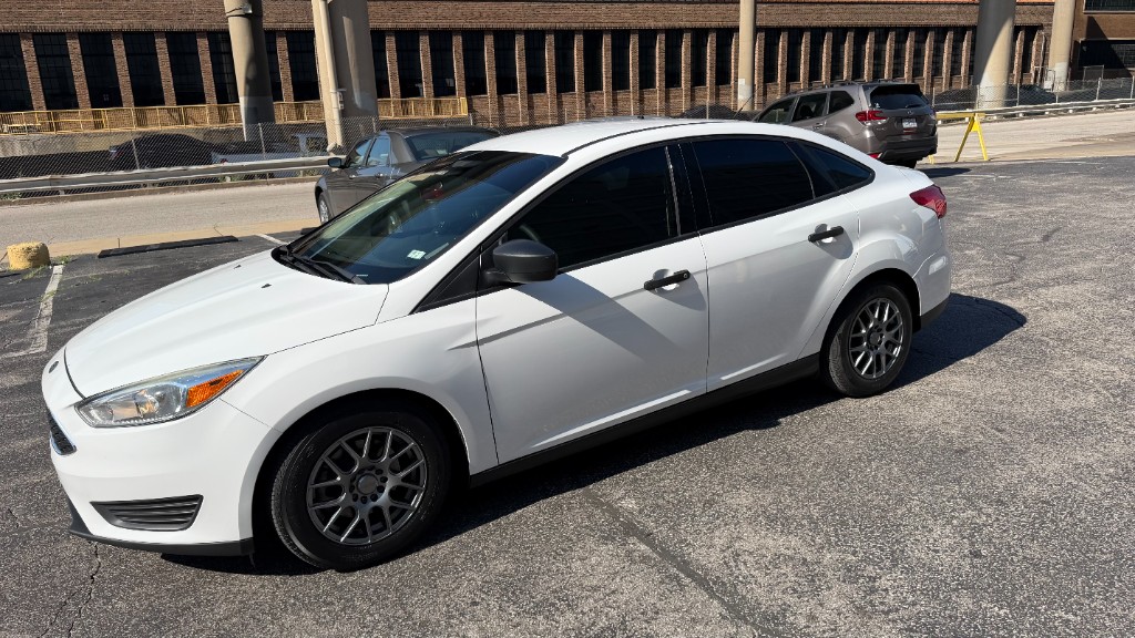White Ford Focus front quarter view showing clean tint lines