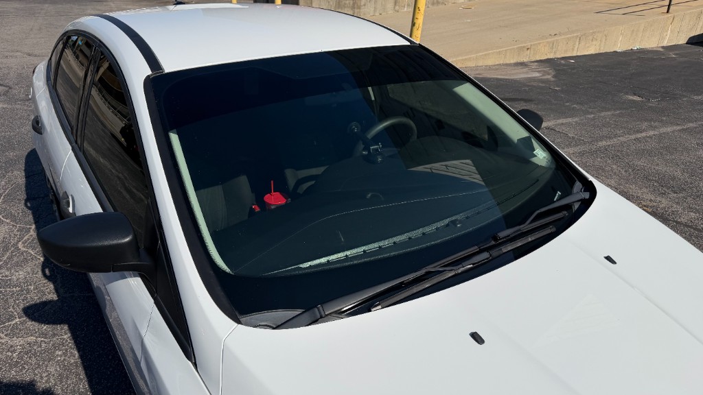 White sedan front windshield view showing premium clear ceramic film