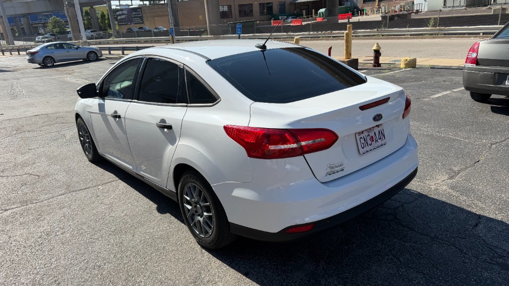 White sedan rear quarter view under direct daylight showing 5% rear side and 20% back windshield tint